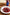 Strawberries in aged balsamic syrup with cracked black pepper, cheesecake in the background