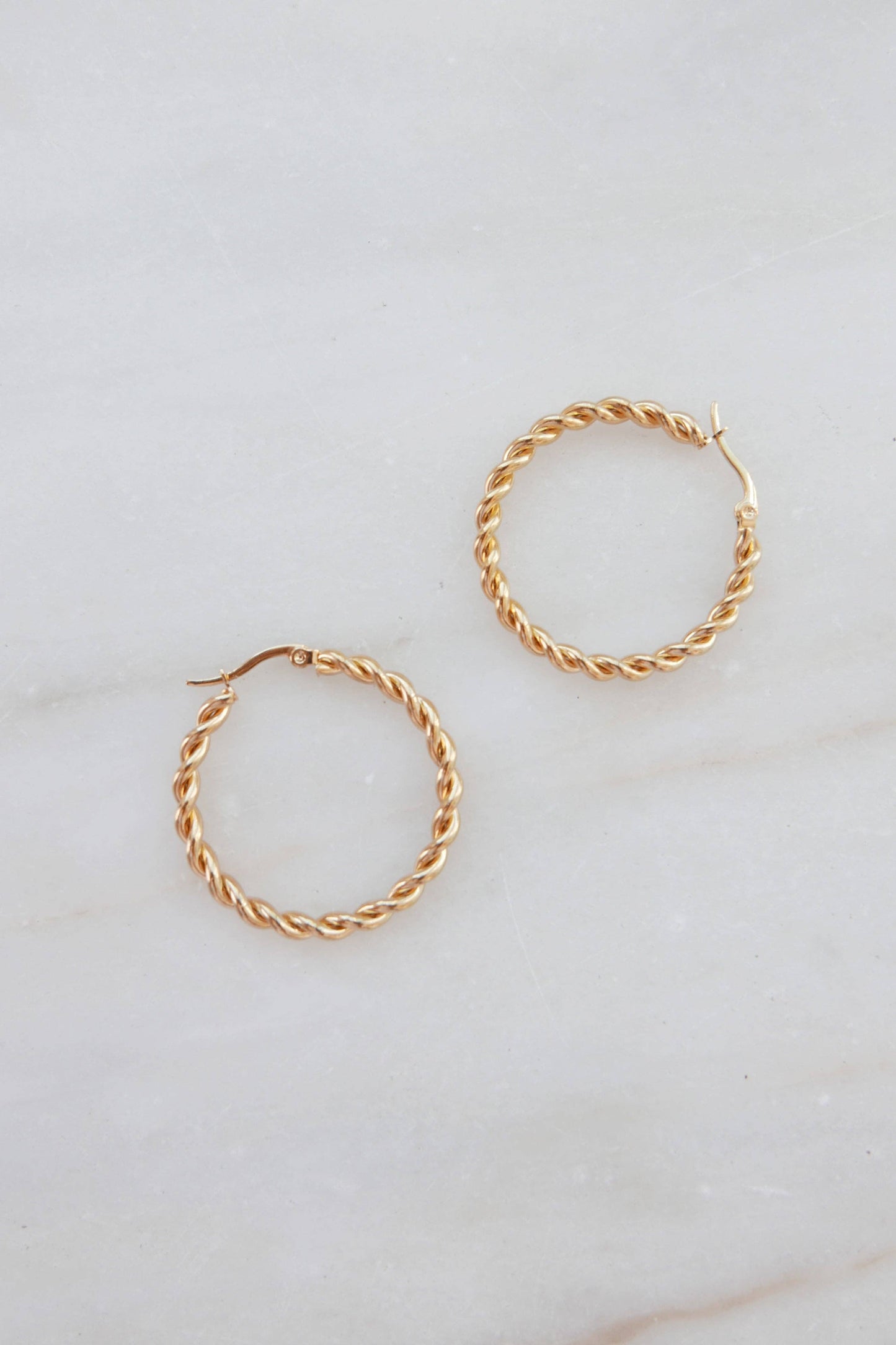 Claudette earrings — thin golden twisted hoops