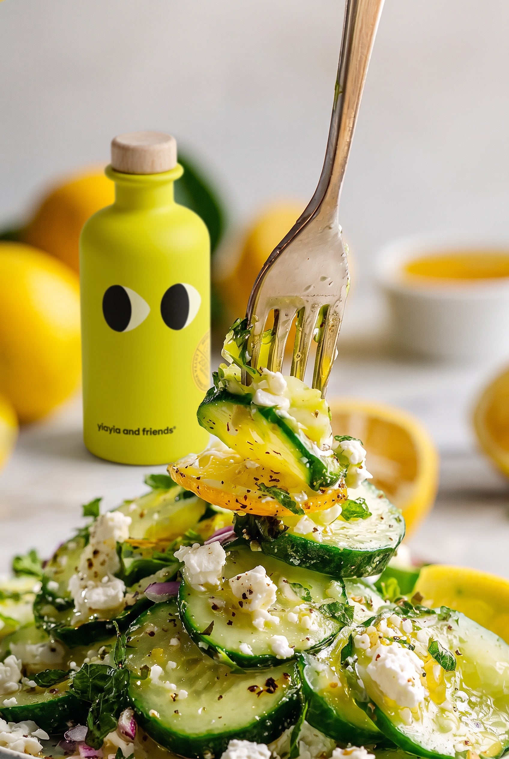 Cucumber salad with feta, mint and lemon olive oil, a forkful lifted above the plate
