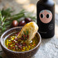 Mediterranean dipping oil with sun-dried tomatoes, garlic, chilli flakes and rosemary, with crusty bread
