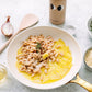Creamy skillet white beans with melted onions, rosemary and garlic olive oil in a white pan